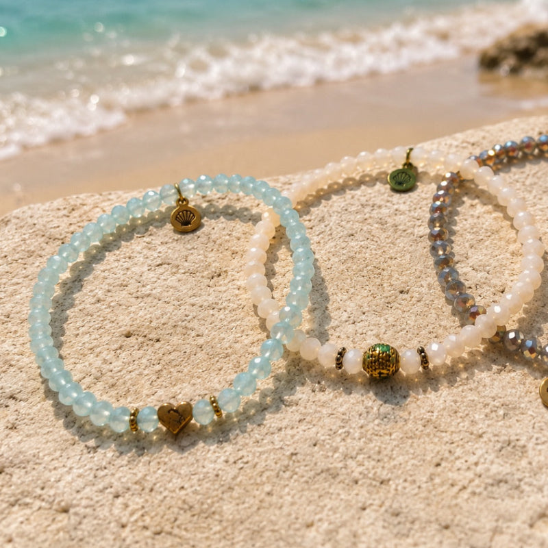 Sparkling faceted glass bead bracelet Blue tone with small gold steel heart charm